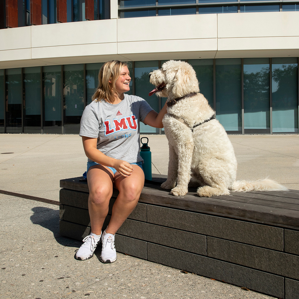 LMU student petting a dog